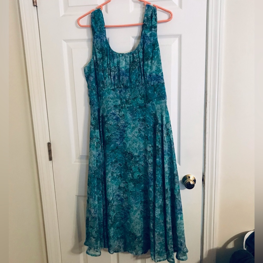 Dress sits just below the knees. With short crop jacket to match.